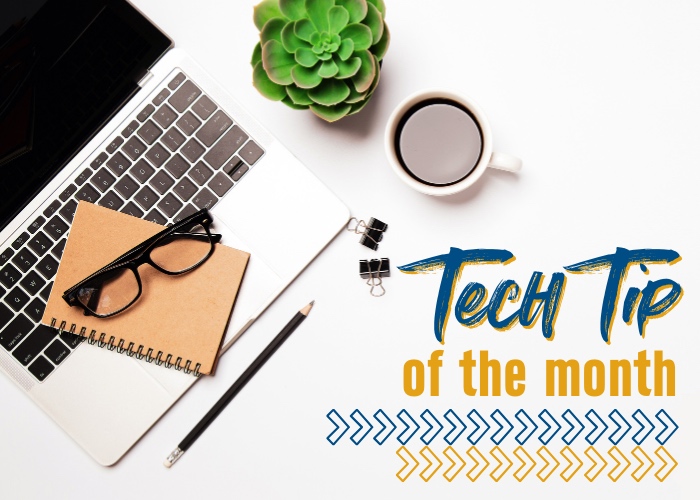 Desk space with laptop, notebook, pencil, glasses, coffee mug, and plant; with words "Tech Tip of the month" in the bottom right corner.