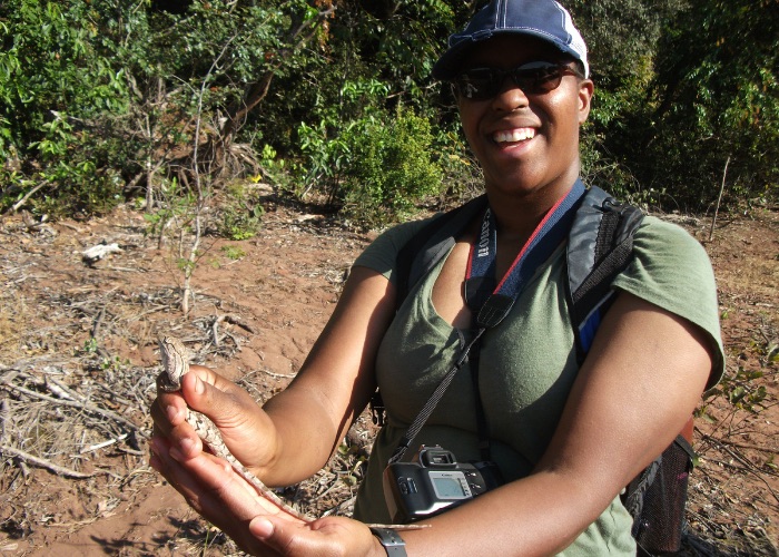 Woman holding lizard during study abroad trip to Brazil.