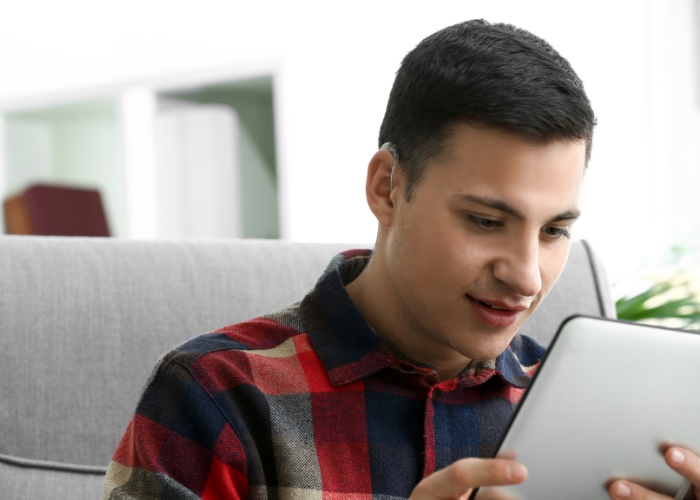 Male with hearing impairment using Ipad.