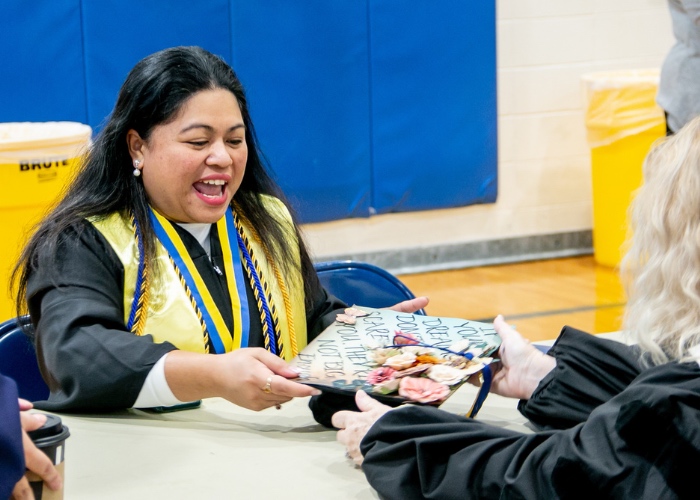 Woman holding cap at a graduation reception.