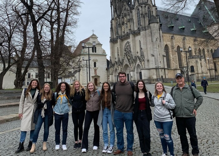 Group photo in front of a cathedral in the Czech Republic.