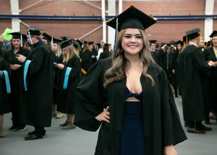 Kara in cap and gown at graduation.