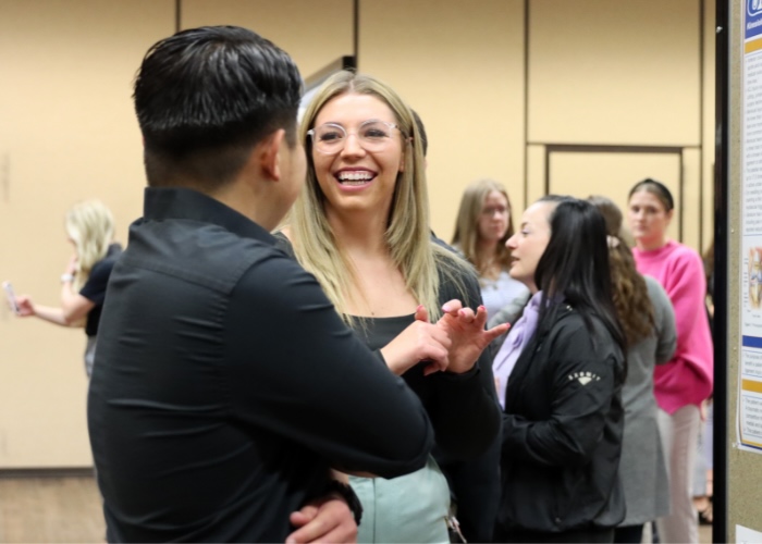Woman smiling at man.