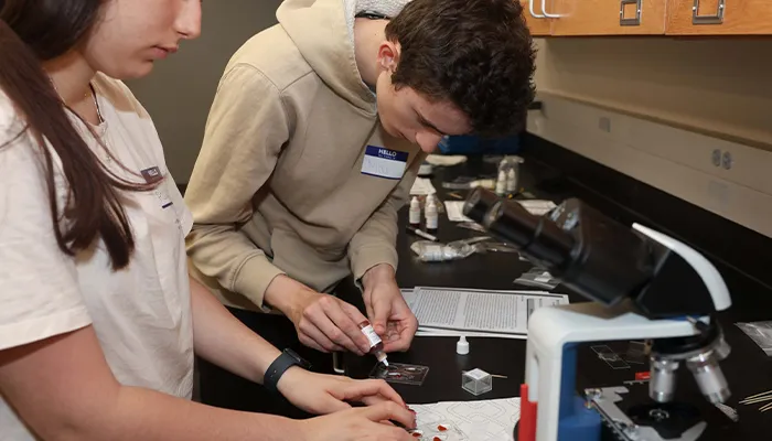 students work in a lab during a health science event