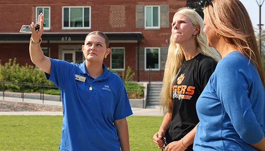 a campus tour guide points out buildings