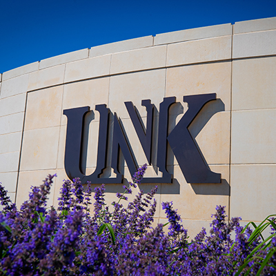 flowers next to a UNK sign on campus