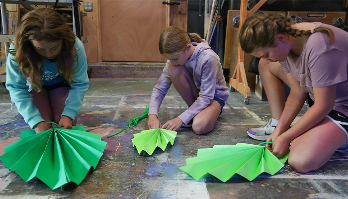 students paint set pieces