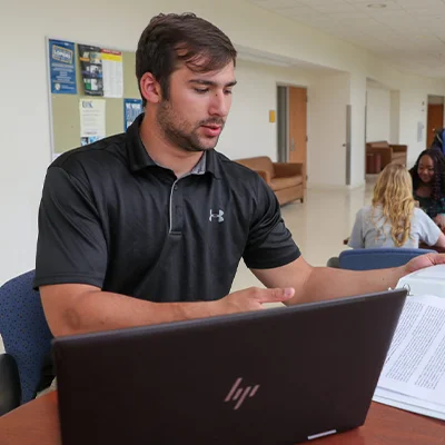 a student works at a laptop