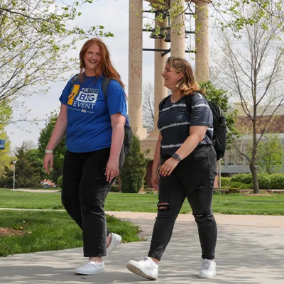 two students walk across campus