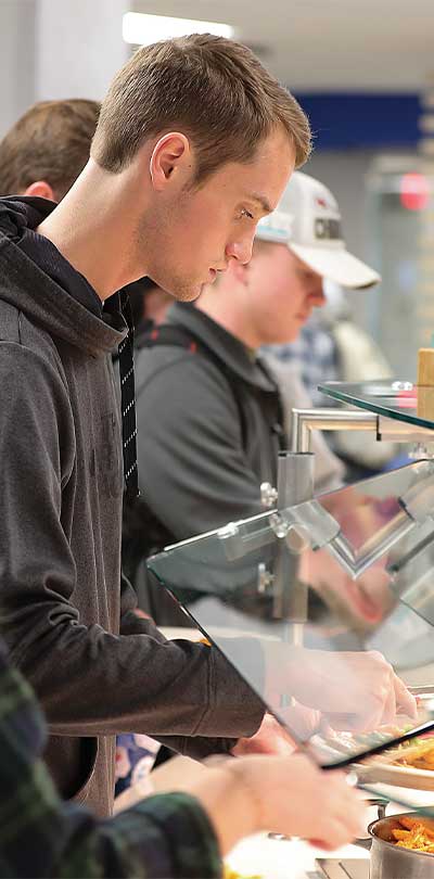 A Sodexo employee preparing food in the Graze