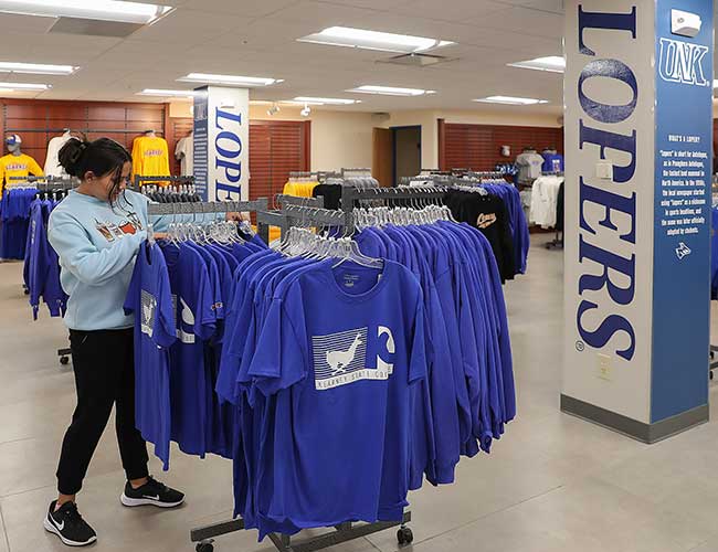 a student browses shirts at the loper spirit shop