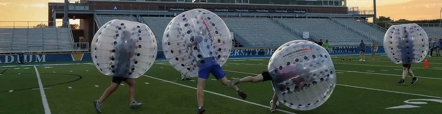 students playing an intramural game in giant inflatable balls