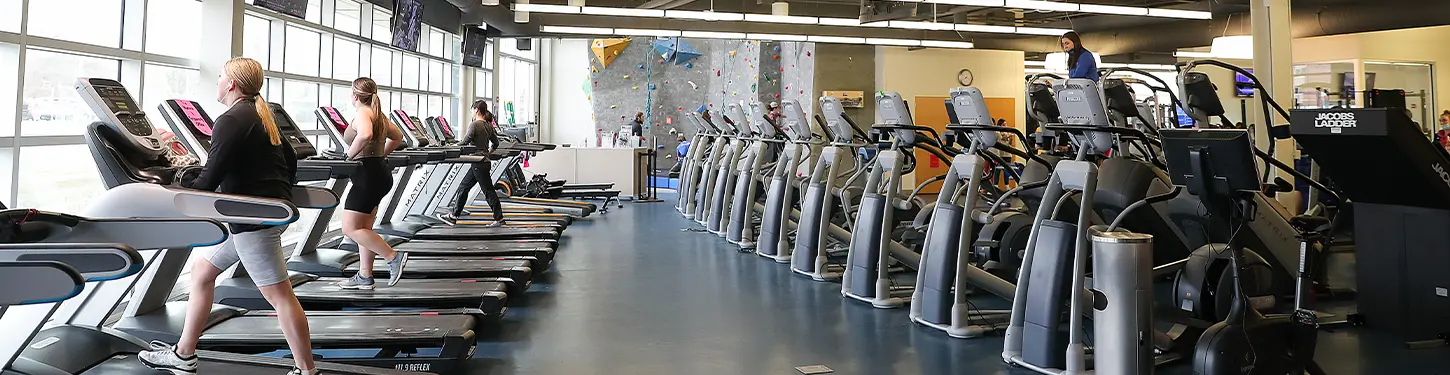 students using fitness machines in the wellness center