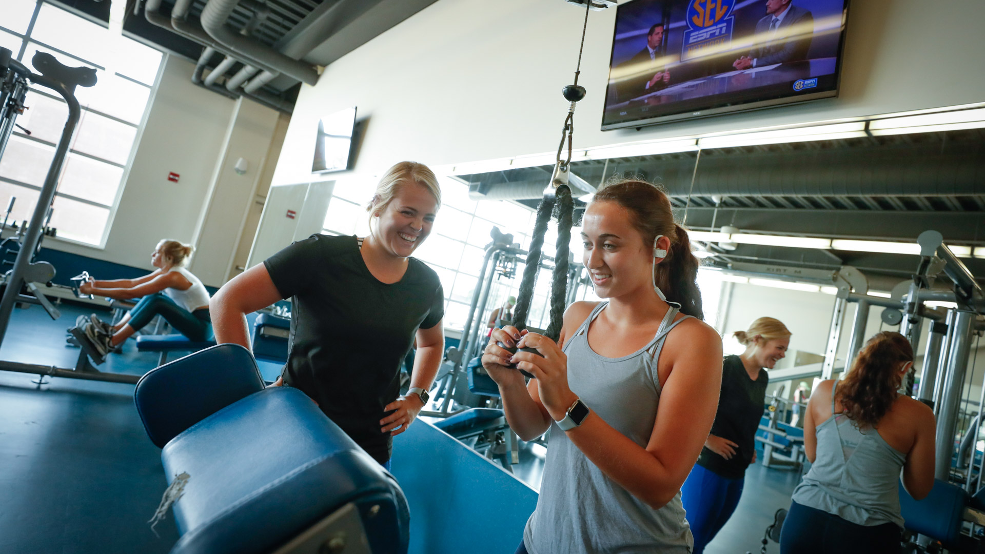 Students using wellness center and weights