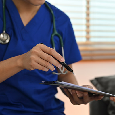 stock photo of a doctor handing a clipboard to a patient