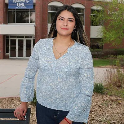 a transfer student poses for a photo outside the student union