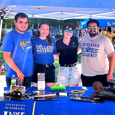 museum staff pose for a photo at the blue gold welcome event