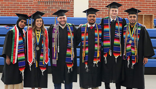 students pose for a photo at graduation