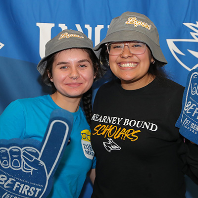 Students pose for a photo holding foam fingers