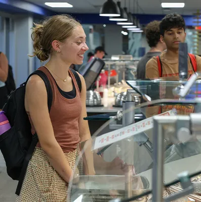 a student stands at a buffet in the dining hall