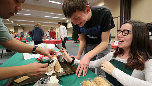 students work on their gingerbread house creation