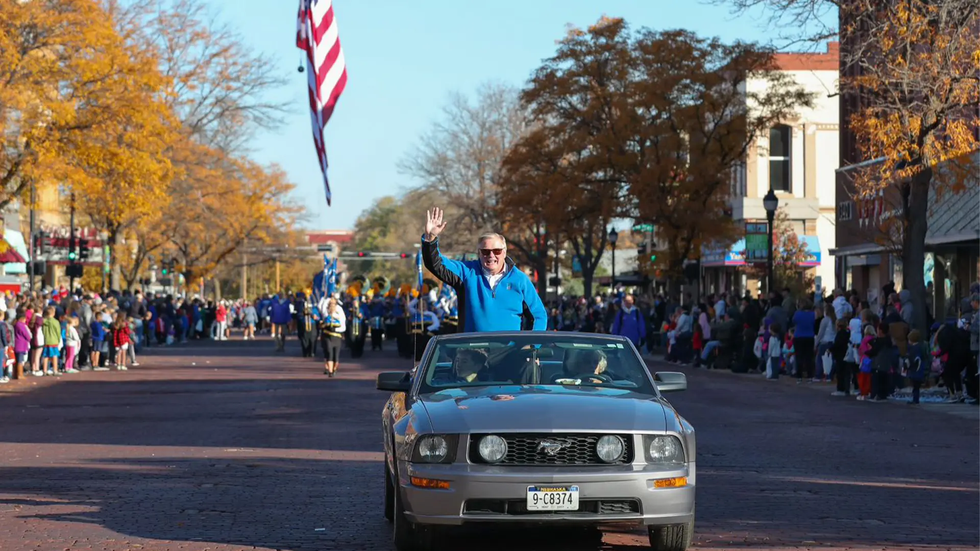 chancellor waving from a car during the homecoming parade