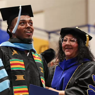 a student receives his diploma at graduation