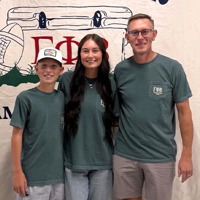 A student poses with her family