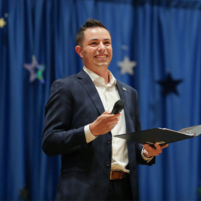 a man holding a microphone MC's an event