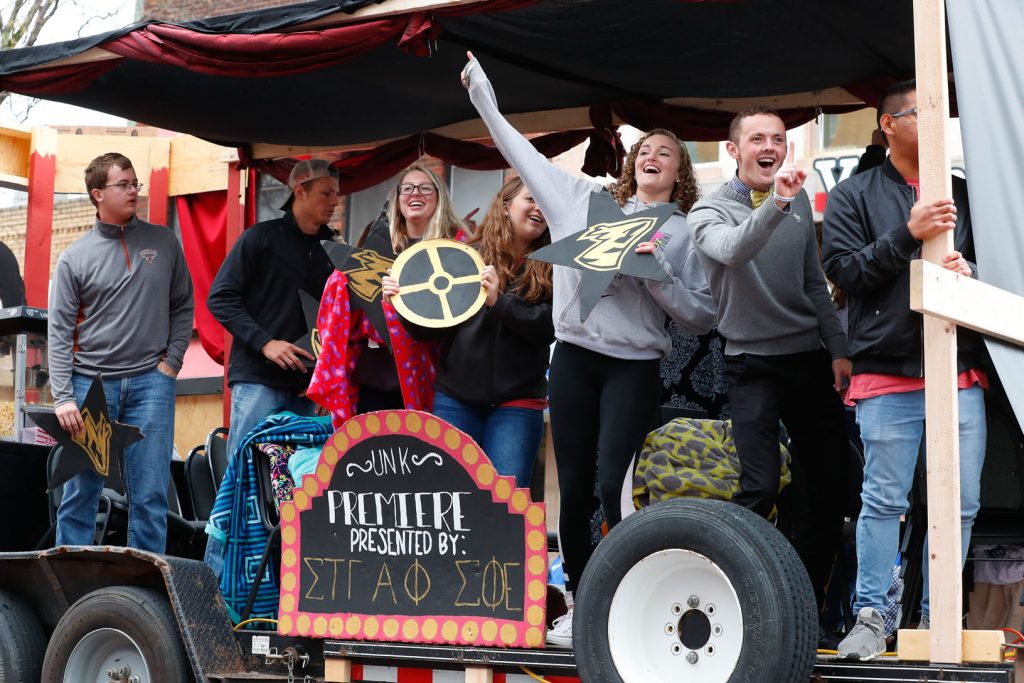 Students riding on homecoming float
