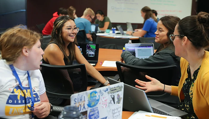 students chat in a library space 