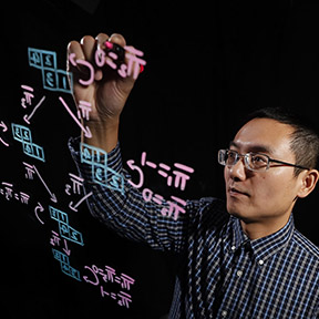 Professor writing on lightboard