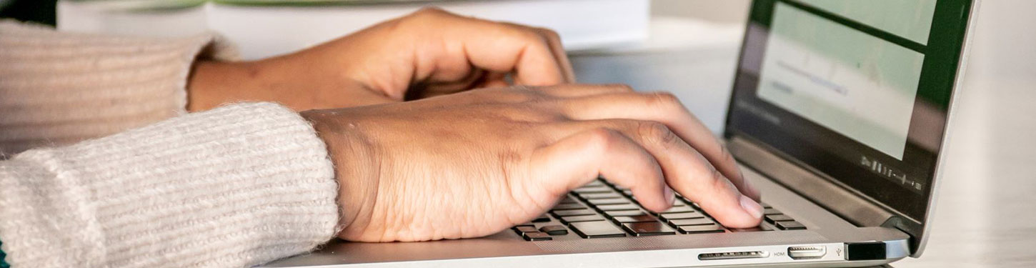 a student types on a laptop