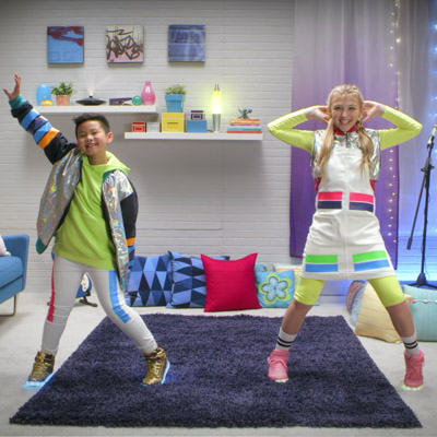 kids dancing in living room of house