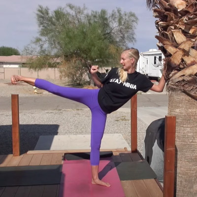 woman showing kicking karate move