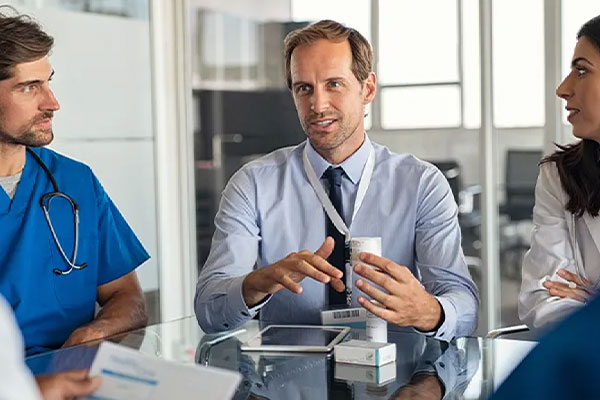 a public health professional speaks to a group of doctors