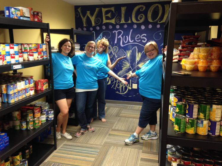 Volunteers working the big blue cupboard