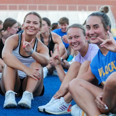 students pose sitting and throwing the lopes
