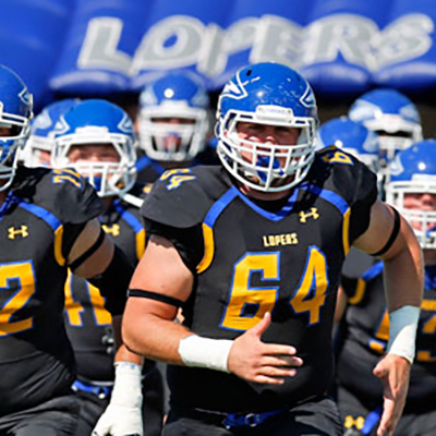 UNK football team running out onto the field
