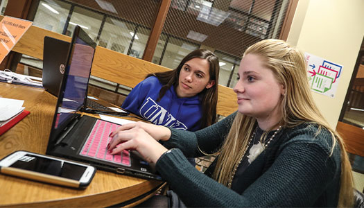 Students viewing a laptop