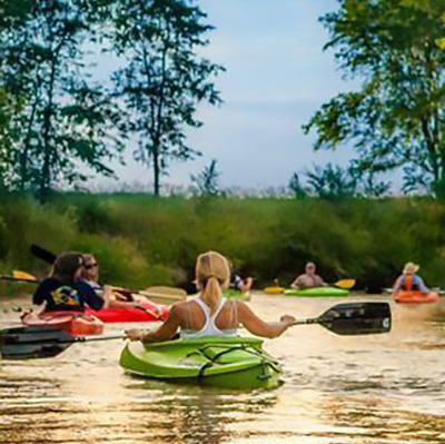 people kayaking on a river