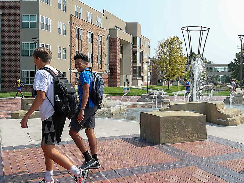 students walking near cope fountain