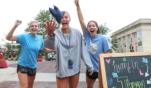 students play cornhole in downtown kearney