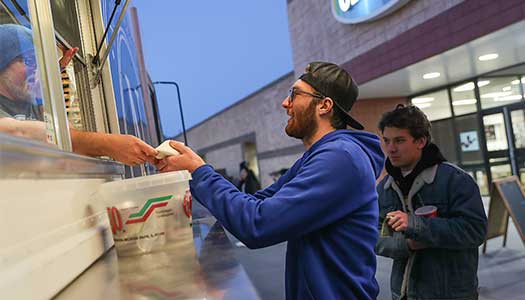 a student gets food from a food truck