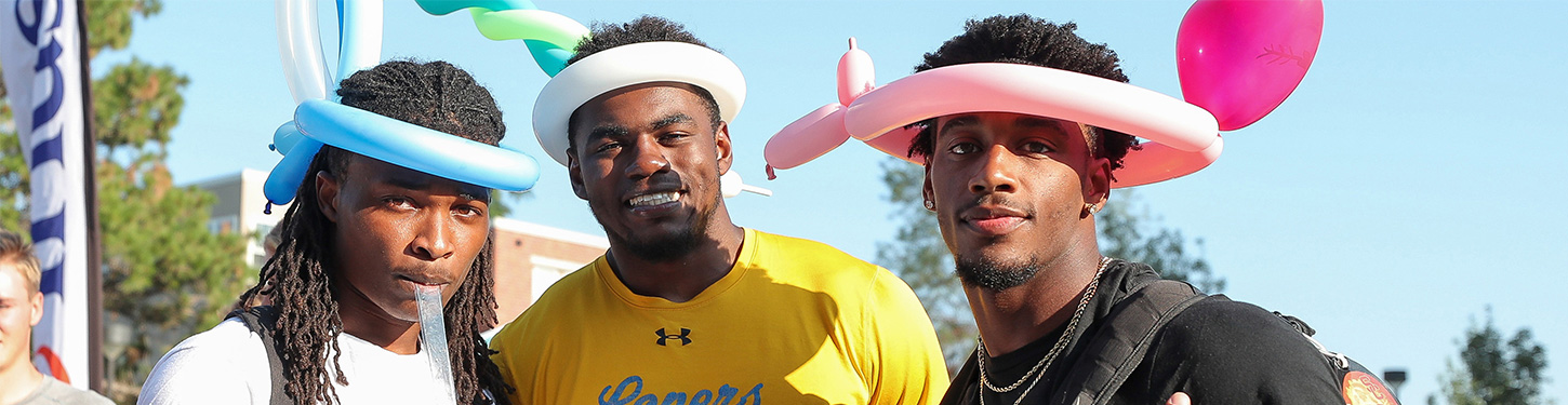 Three students pose during the welcome back showcase