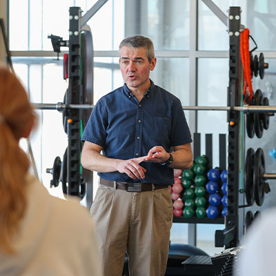 a faculty member teaches in a weight room
