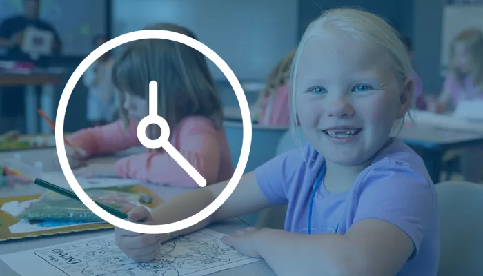 a young girl smiles at the camera while coloring an of a clock is superimposed on the picture