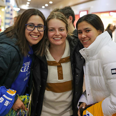 image of students posing together at a welcome home event in the mall